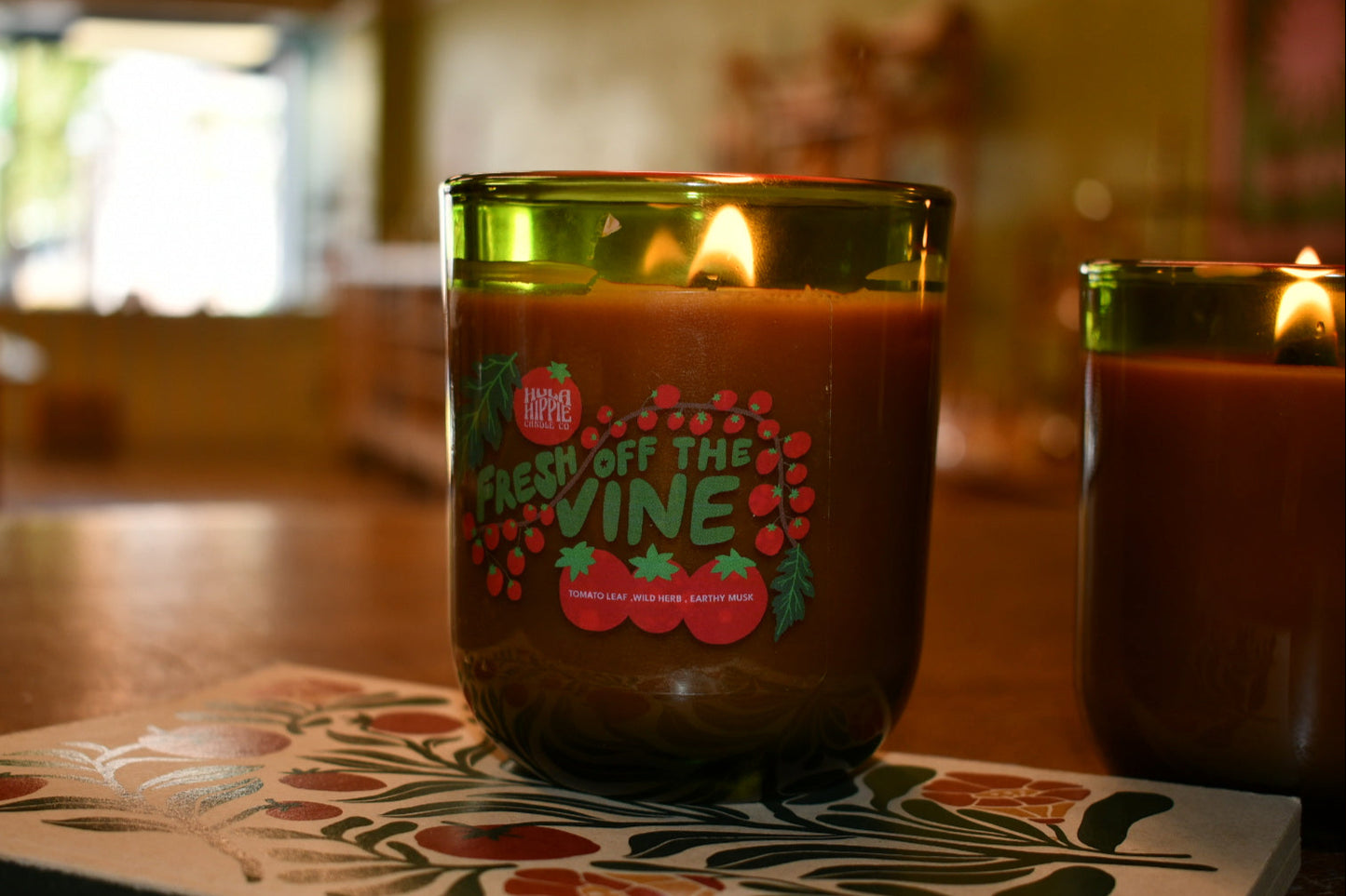 Candle with 'Fresh Off the Vine' label on a decorative coaster
