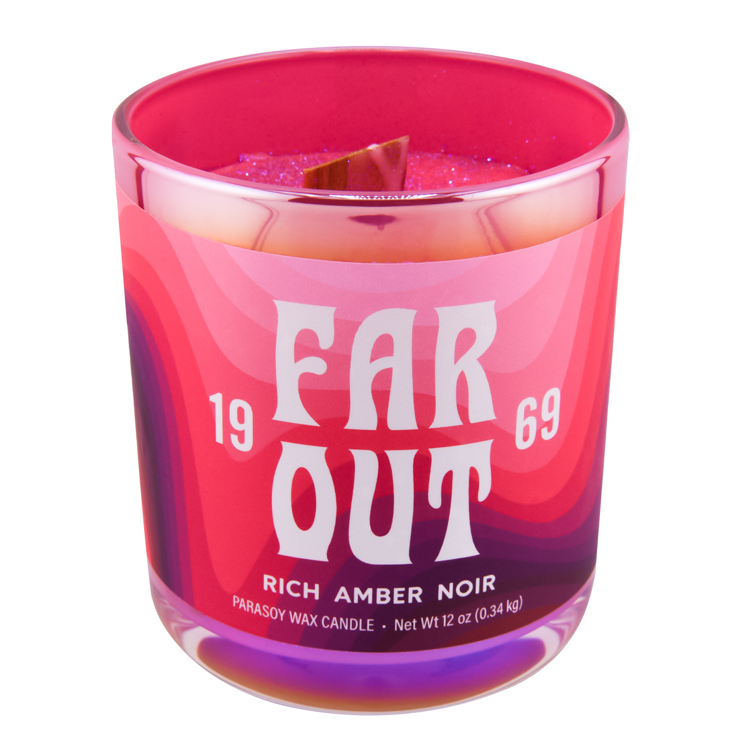 A pink and purple candle with the text 'FAR OUT 1969 RICH AMBER NOIR' on the label, scented with rich amber noir.