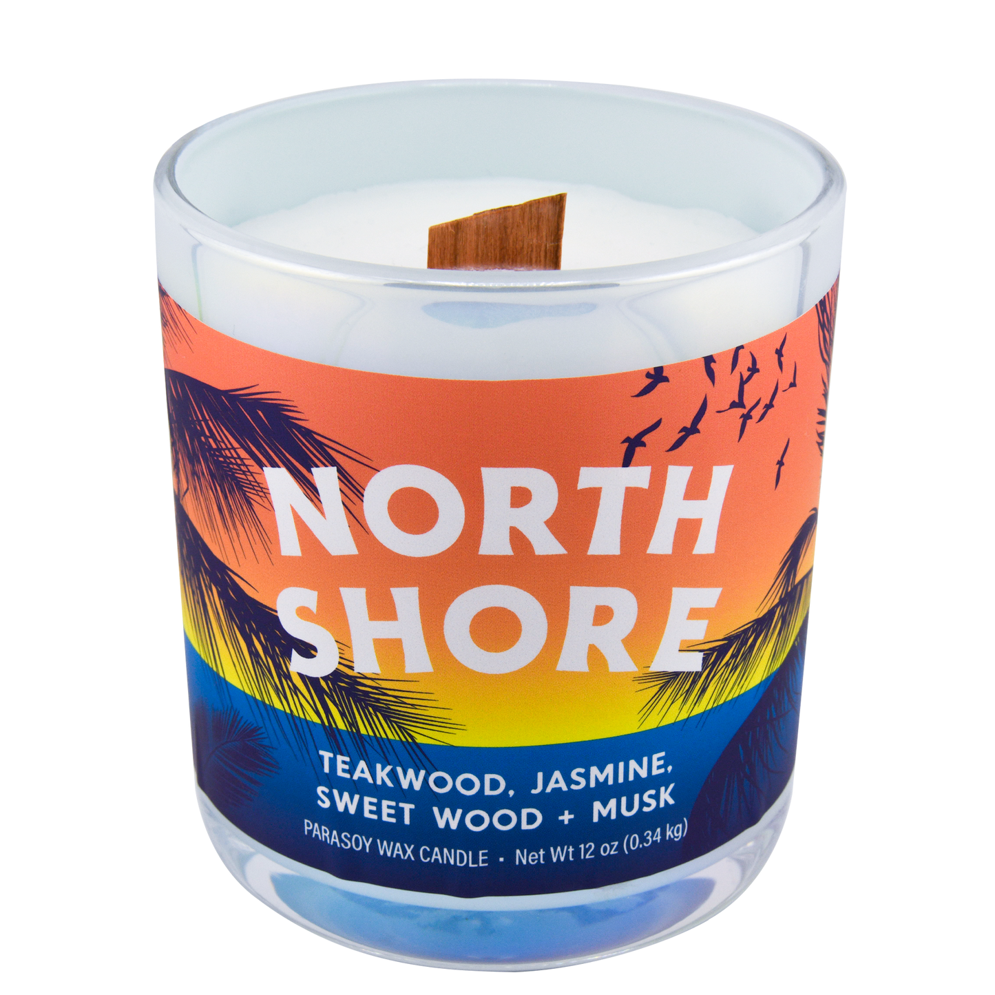 Right-side view of a scented candle in an iridescent jar labeled "North Shore" with notes of teakwood and jasmine.