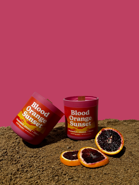 Two 12oz wood wick candles with pink jars With the "Blood orange sunset" label scented with Grapefruit, Orange & Cedar.