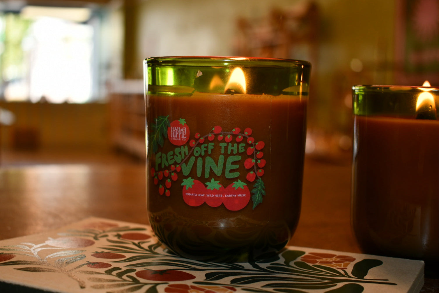 Candle with 'Fresh Off the Vine' label on a decorative coaster