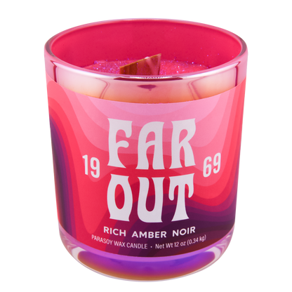 A pink and purple candle with the text 'FAR OUT 1969 RICH AMBER NOIR' on the label, scented with rich amber noir.