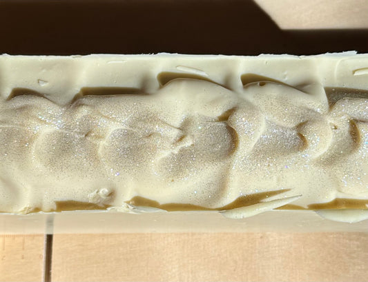 Close-up of a bar of soap with a textured surface on a wooden background