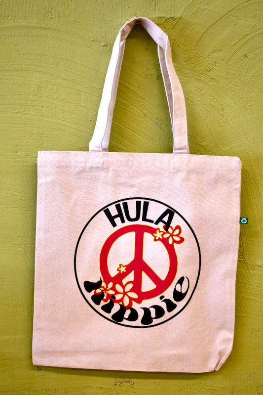 Hanging canvas peace sign tote with hibiscus within the peace sign and the words Hula Hippie warped around the peace sign
