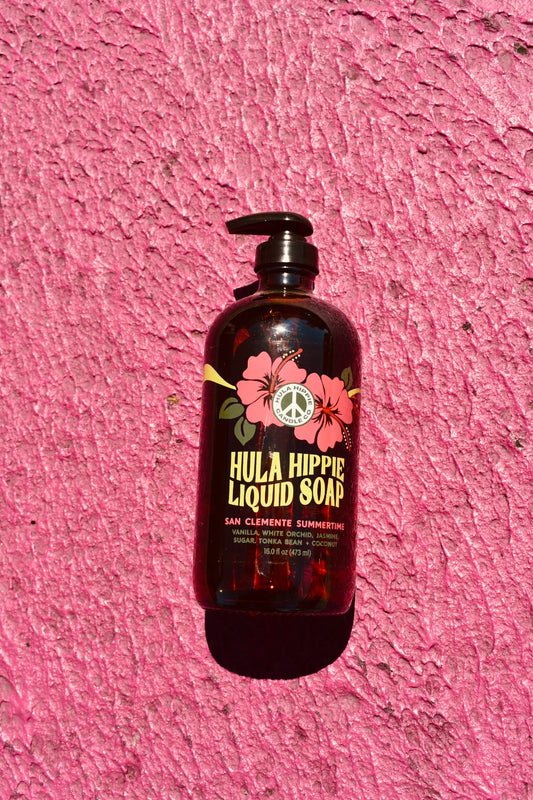 Bottle of Sanclemente Summertime Liquid Soap from Hula Hippie Candle Co. 16oz pumpable soap with hibiscus logo. scented with Vanilla, white orchid, tonka bean ,coconut
